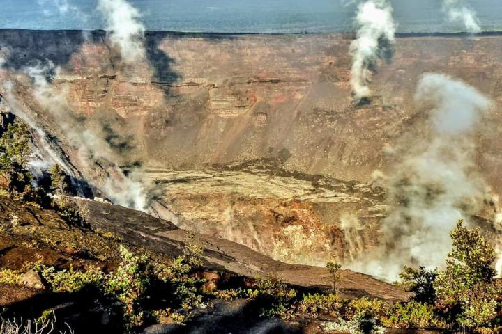 a steam train on a track with smoke coming out of it