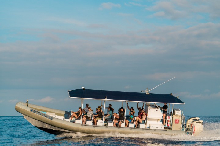 a group of people on a boat in the water