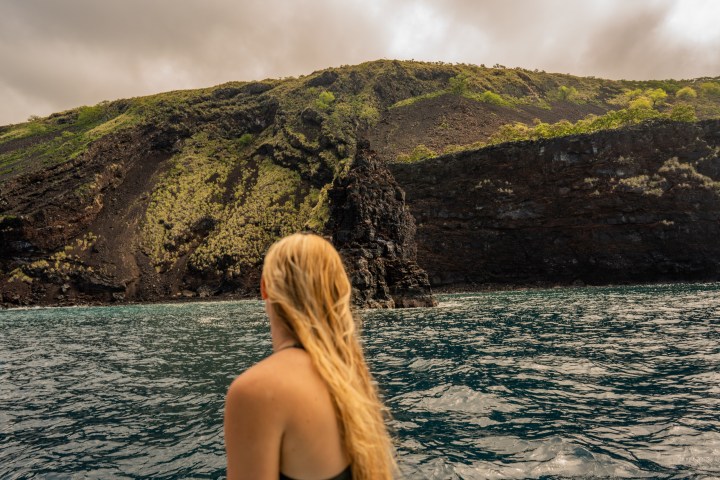 a person sitting next to a body of water