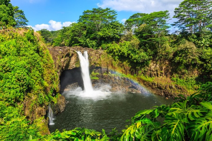 a large waterfall over a body of water with Rainbow Falls in the background